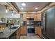 Eat in kitchen features stainless steel appliances and granite countertops at 767 Tenderfoot Dr, Larkspur, CO 80118