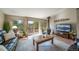 Inviting living room with wood stove, deck access, and abundant natural light at 767 Tenderfoot Dr, Larkspur, CO 80118