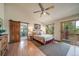 Bright main bedroom with vaulted ceilings, ensuite bath, and a private deck entrance at 767 Tenderfoot Dr, Larkspur, CO 80118