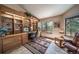 Well-lit office space with built-in bookshelves, a comfortable chair, and outside view at 767 Tenderfoot Dr, Larkspur, CO 80118