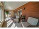 Inviting covered porch with abundant natural light and multiple seating areas at 767 Tenderfoot Dr, Larkspur, CO 80118