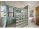 Modern shower design with glass block partition and stylish fixtures in the ensuite bath at 767 Tenderfoot Dr, Larkspur, CO 80118