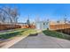 Large backyard showing off a two car garage, lush green grass, and a newly concreted pad at 3931 King St, Denver, CO 80211