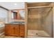Updated bathroom features a double vanity, granite counters, and a tiled shower with glass door at 3931 King St, Denver, CO 80211