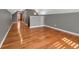 Open bonus room featuring gleaming hardwood floors, neutral paint, and an abundance of natural light at 3931 King St, Denver, CO 80211