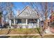 Charming home featuring a lovely front porch with decorative columns and a well-maintained lawn at 3931 King St, Denver, CO 80211