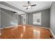 Spacious living room with hardwood floors, ceiling fan, and large windows, creating a bright and inviting space at 3931 King St, Denver, CO 80211