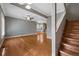 Open-concept living area with hardwood floors and staircase access, perfect for Gathering gatherings at 3931 King St, Denver, CO 80211