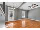 Bright living room with hardwood floors, ceiling fan, and a classic entrance door at 3931 King St, Denver, CO 80211