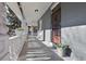 Covered porch with decorative columns and ample space, perfect for enjoying the outdoors at 3931 King St, Denver, CO 80211