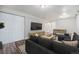 Cozy basement area with a dark sectional, TV, and foosball table for entertainment at 9712 Adams St, Thornton, CO 80229