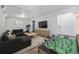 Entertainment basement area with a sectional couch, foosball table, and large tv, perfect for recreation at 9712 Adams St, Thornton, CO 80229