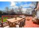 Inviting outdoor deck featuring a dining table, seating area, and a tranquil view of the backyard at 9712 Adams St, Thornton, CO 80229