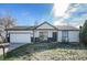 Charming single-story home with a well-manicured lawn and attached two-car garage, exuding curb appeal at 9712 Adams St, Thornton, CO 80229