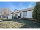 Charming exterior of a home with a well-manicured lawn and stylish black and white color scheme at 9712 Adams St, Thornton, CO 80229