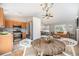 Open concept kitchen and living room with stainless steel appliances, hardwood floors, and plenty of natural light at 9712 Adams St, Thornton, CO 80229