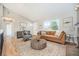 Bright living room with hardwood floors, a large window, and stylish furniture at 9712 Adams St, Thornton, CO 80229