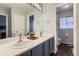 Bright bathroom featuring a double vanity, modern fixtures, and a view of the toilet room at 9758 Laredo St # 1E, Commerce City, CO 80022