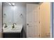 Clean half bath with a white sink, modern faucet, and a gray vanity at 9758 Laredo St # 1E, Commerce City, CO 80022