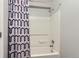 Bathroom shower with white shower curtain and chrome fixtures at 9758 Laredo St # 1E, Commerce City, CO 80022