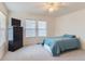Bedroom with ceiling fan, carpet floors, two windows, and dark dresser at 9758 Laredo St # 1E, Commerce City, CO 80022