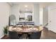 Dining area with wooden table set for four and view to the kitchen with stainless appliances at 9758 Laredo St # 1E, Commerce City, CO 80022