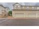 Exterior view of townhome garages and parking spaces at 9758 Laredo St # 1E, Commerce City, CO 80022