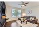 Inviting living room featuring hardwood floors, a sectional couch, and bright natural light at 9758 Laredo St # 1E, Commerce City, CO 80022