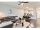 Open concept living room with view to the kitchen; features hardwood floors and modern furnishings at 9758 Laredo St # 1E, Commerce City, CO 80022