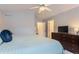 Tranquil main bedroom showcasing a large dresser, king bed, and neutral decor at 9758 Laredo St # 1E, Commerce City, CO 80022