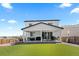 Backyard with covered patio, artificial turf and gravel landscaping at 140 Vista Cliff Cir, Castle Rock, CO 80104