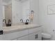 Bright bathroom with double sinks, white cabinets, and toilet at 140 Vista Cliff Cir, Castle Rock, CO 80104