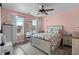 Comfortable bedroom with large bed, ceiling fan, and windows at 140 Vista Cliff Cir, Castle Rock, CO 80104