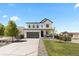 Attractive two-story home with a well-manicured lawn and a long driveway at 140 Vista Cliff Cir, Castle Rock, CO 80104