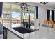 Kitchen sink and quartz countertop with a view to the patio at 140 Vista Cliff Cir, Castle Rock, CO 80104