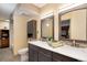 Bathroom featuring a dual vanity with matching mirrors and ample cabinet space at 2880 S Locust St # 505N, Denver, CO 80222