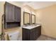 Bathroom featuring a dual vanity with matching mirrors and ample cabinet space at 2880 S Locust St # 505N, Denver, CO 80222