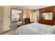 Spacious bedroom with stylish brick accent wall and seating area, offering great views at 2880 S Locust St # 505N, Denver, CO 80222