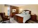 Comfortable bedroom with wood furniture, a queen bed, and a view at 2880 S Locust St # 505N, Denver, CO 80222