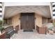 Elegant building entrance features carved wood doors, brick facade and bench at 2880 S Locust St # 505N, Denver, CO 80222