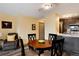 Dining area adjacent to updated kitchen with dark cabinetry and wood-look flooring at 2880 S Locust St # 505N, Denver, CO 80222