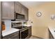 Modern kitchen featuring stainless steel appliances, tile backsplash and white quartz countertops at 2880 S Locust St # 505N, Denver, CO 80222