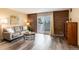 Comfortable living room features neutral paint, balcony access and wood-look floors at 2880 S Locust St # 505N, Denver, CO 80222