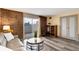 Cozy living area with exposed brick wall and sliding glass door to balcony and built-in bookcase at 2880 S Locust St # 505N, Denver, CO 80222