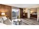 Inviting living room features exposed brick, sliding glass doors to balcony and wood-look flooring at 2880 S Locust St # 505N, Denver, CO 80222