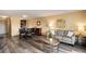 Open concept living with eat-in kitchen with breakfast bar and updated cabinetry, wood-look flooring at 2880 S Locust St # 505N, Denver, CO 80222