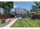 Well-manicured backyard featuring a lush lawn, patio area, and privacy fence at 3182 W 29Th Ave, Denver, CO 80211