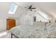 Bright attic bedroom with carpet flooring, skylight, and ample natural light at 3182 W 29Th Ave, Denver, CO 80211