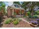 Charming brick home with a landscaped front yard and covered porch seating area at 3182 W 29Th Ave, Denver, CO 80211