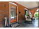 Inviting front porch with an orange door, cozy seating, and decorative welcome mat at 3182 W 29Th Ave, Denver, CO 80211